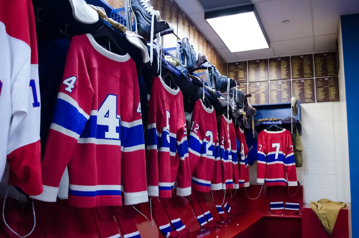 Team jerseys hanging in a locker room